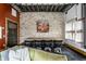 Dining space featuring stone wall, chandelier and an oversized wooden dining table at 2417 E 80Th E St, Indianapolis, IN 46240
