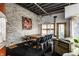 Dining room features chandelier, brick wall and an adjacent sitting area at 2417 E 80Th E St, Indianapolis, IN 46240
