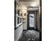 Hallway with window, gray door, artwork, ceiling lighting, and carpeted flooring at 2417 E 80Th E St, Indianapolis, IN 46240