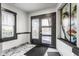 Stylish front foyer with marble floors, modern lighting, and a beautifully designed entry door at 2417 E 80Th E St, Indianapolis, IN 46240