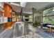 Open kitchen with a stainless steel island, unique orange accent wall, and breakfast nook with views to the yard at 2417 E 80Th E St, Indianapolis, IN 46240