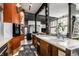 Modern kitchen offers ample counter space with barstool seating and unique orange-colored accent wall with fish tank at 2417 E 80Th E St, Indianapolis, IN 46240