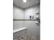 Modern tiled shower with a built-in seat, contemporary fixtures, and ample space, providing a clean and comfortable experience at 2417 E 80Th E St, Indianapolis, IN 46240