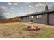View of the backyard featuring a cozy fire pit and well-maintained lawn at 2625 15Th St, Columbus, IN 47201