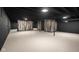 Spacious basement with dark walls, light flooring, and rustic wood accent at 2625 15Th St, Columbus, IN 47201