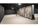 Partially finished basement with dark walls, light flooring, and rustic wood accent at 2625 15Th St, Columbus, IN 47201