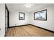 Bright bedroom featuring wood floors, black trim, and ample natural light from the large window at 2625 15Th St, Columbus, IN 47201