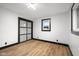 Bedroom featuring sliding closet door, wood floors, white walls and a double-paned window at 2625 15Th St, Columbus, IN 47201