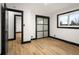 Bedroom featuring wood floors, closet with sliding glass doors, and a double-paned window at 2625 15Th St, Columbus, IN 47201