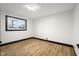 Bright bedroom with white walls, wood floors, and natural light from a double-paned window at 2625 15Th St, Columbus, IN 47201