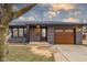 Exterior front entrance features bright address numbers, concrete steps, and wooden garage door at 2625 15Th St, Columbus, IN 47201