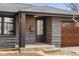 Close up of the front entrance with stone exterior, bright address numbers and wooden garage door at 2625 15Th St, Columbus, IN 47201