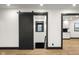 Charming hallway features a wood sliding door and a view of the kitchen at 2625 15Th St, Columbus, IN 47201