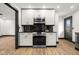 Modern kitchen features white cabinets, black countertop, and stainless steel appliances at 2625 15Th St, Columbus, IN 47201