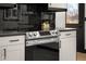 Updated kitchen features stainless steel oven with black countertops and white cabinets at 2625 15Th St, Columbus, IN 47201