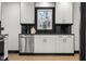 Updated kitchen with white cabinets, stainless steel dishwasher, and black hardware at 2625 15Th St, Columbus, IN 47201