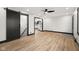 Living room with wood floors, modern black and white trim, and a ceiling fan at 2625 15Th St, Columbus, IN 47201