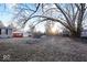 A backyard with trees and multiple small outbuildings at 3130 Elizabeth St, Indianapolis, IN 46234