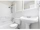 Bathroom features a white sink, toilet, and bathtub/shower combination at 3130 Elizabeth St, Indianapolis, IN 46234