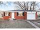 Charming brick ranch-style house with a well-maintained front yard and attached garage at 3130 Elizabeth St, Indianapolis, IN 46234