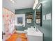 Bathroom featuring a window, sink, toilet, and tub with shower curtain at 320 15Th St, Columbus, IN 47201