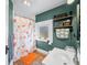 Charming bathroom featuring a goldfish shower curtain, natural light, and rustic shelving at 320 15Th St, Columbus, IN 47201