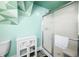 Bathroom exhibiting light green walls, a glass shower, toilet, and vanity cabinet with toilet paper at 320 15Th St, Columbus, IN 47201