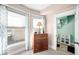 Bedroom displaying a dresser with a lamp, a large window for natural light and calming neutral tones at 320 15Th St, Columbus, IN 47201