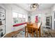 Inviting dining area with a window bench, hardwood floors, and a stylish light fixture at 320 15Th St, Columbus, IN 47201