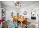 Spacious dining area with a large table, decorative rug, and views into the kitchen and bedroom at 320 15Th St, Columbus, IN 47201