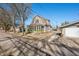 Street view of a charming two-story home with a screened front porch and long driveway at 320 15Th St, Columbus, IN 47201