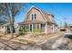 Charming two-story home with a screened front porch and well-maintained landscaping at 320 15Th St, Columbus, IN 47201