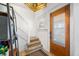 Entryway with wooden front door, carpeted stairs, and elegant lighting fixture at 320 15Th St, Columbus, IN 47201