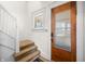 Warm and inviting foyer with a glass-paneled door and adjacent stairway at 320 15Th St, Columbus, IN 47201