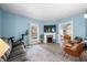 Cozy living room with light blue walls, comfortable seating, and a decorative fireplace at 320 15Th St, Columbus, IN 47201