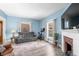 Comfortable living room with a gray sofa, white mantel fireplace, and updated flooring at 320 15Th St, Columbus, IN 47201