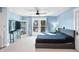 Spacious main bedroom with ceiling fan, large window, and light blue walls at 320 15Th St, Columbus, IN 47201
