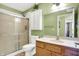 Bathroom with green walls, vanity, toilet and shower with sliding glass doors at 4139 Bella Ct, Indianapolis, IN 46237