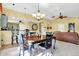 Open dining space with a view of kitchen and living room, featuring a chandelier and bar seating at 4139 Bella Ct, Indianapolis, IN 46237