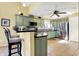 Well-lit kitchen with stainless steel appliances, tile backsplash, and a breakfast bar with seating at 4139 Bella Ct, Indianapolis, IN 46237