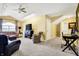 Open living room with vaulted ceiling, ceiling fan, track lighting, comfortable seating and desk area at 4139 Bella Ct, Indianapolis, IN 46237