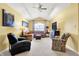 Bright living room with vaulted ceiling, fan, track lighting, comfortable seating and large window at 4139 Bella Ct, Indianapolis, IN 46237