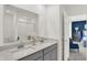 Elegant bathroom with dual sinks, white countertops, and a view to the bedroom at 4435 Laughter Ln, Indianapolis, IN 46235
