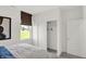 Bright bedroom featuring a closet and a window with view of a barn at 4435 Laughter Ln, Indianapolis, IN 46235