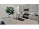 Close-up of kitchen island featuring granite countertops, stainless steel sink, faucet, and modern appliances at 4435 Laughter Ln, Indianapolis, IN 46235
