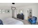 Bright main bedroom showcasing a modern light fixture and comfortable blue chair at 4435 Laughter Ln, Indianapolis, IN 46235