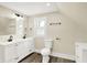 Bathroom featuring a dual sink vanity, toilet, and hardwood floors at 462 W Broadway St, Greenwood, IN 46142
