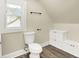 Bathroom featuring a toilet, hardwood floors, and fixtures at 462 W Broadway St, Greenwood, IN 46142