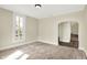 Neutral bedroom featuring a large window and neutral carpet at 462 W Broadway St, Greenwood, IN 46142