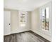 Bright bedroom with neutral walls, wood-look flooring and large windows at 462 W Broadway St, Greenwood, IN 46142